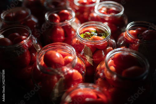 preservation and placing of red tomatoes in a glass jar