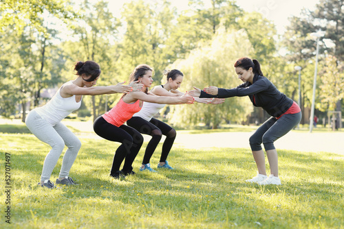 Group of people doing flexibility exercises at the park