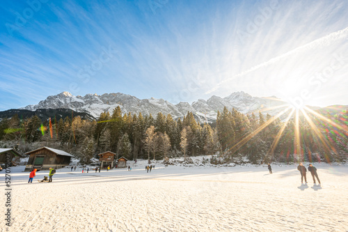 sunny landscape of Zugspitze, the top of germany, from frozen eibsee lake photo