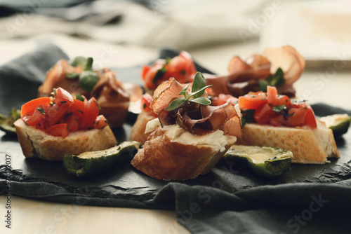 Delicious snacks in the form of mini sandwiches with meat and vegetables for the party