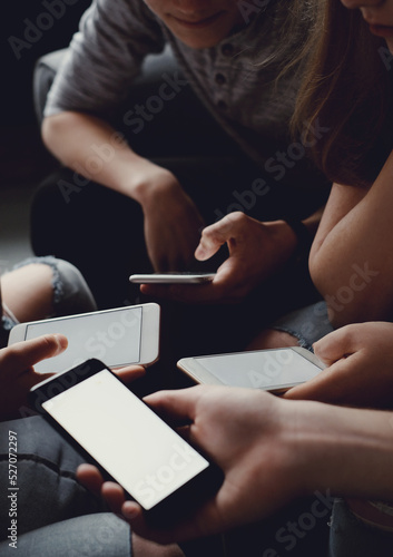 Group of friends having fun with smartphones