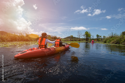 boats, rowing, sports and ecotourism in the country. Equipment for rafting, Two Asian women kayaking in the river in summer active recreation family trip Extreme adventure