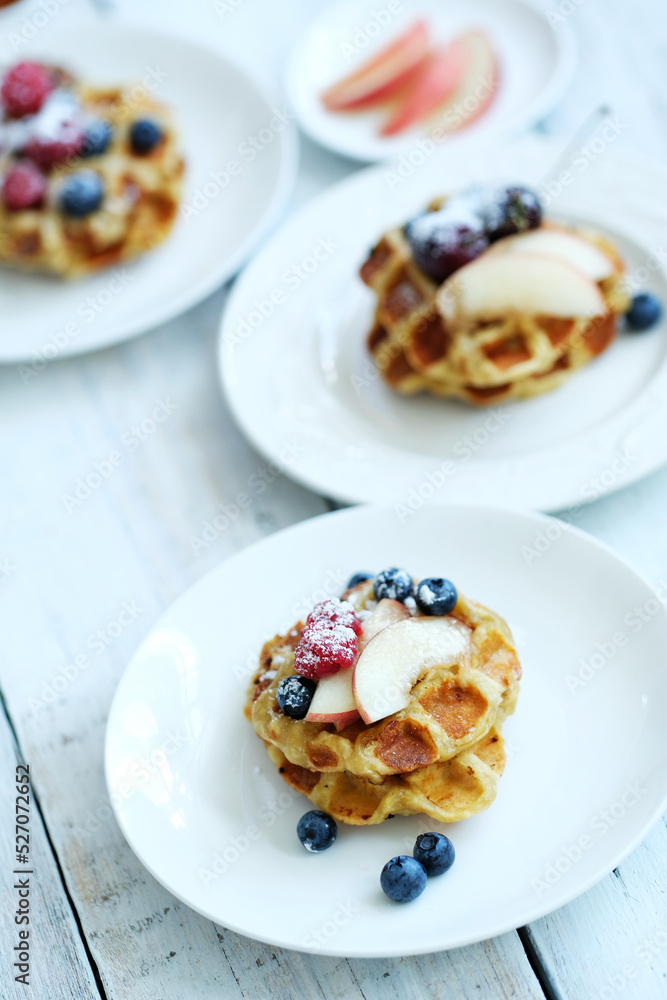 Mini Waffles with berries for the breakfast on a white plate Mini Waffles with berries for the breakfast on a white plate
