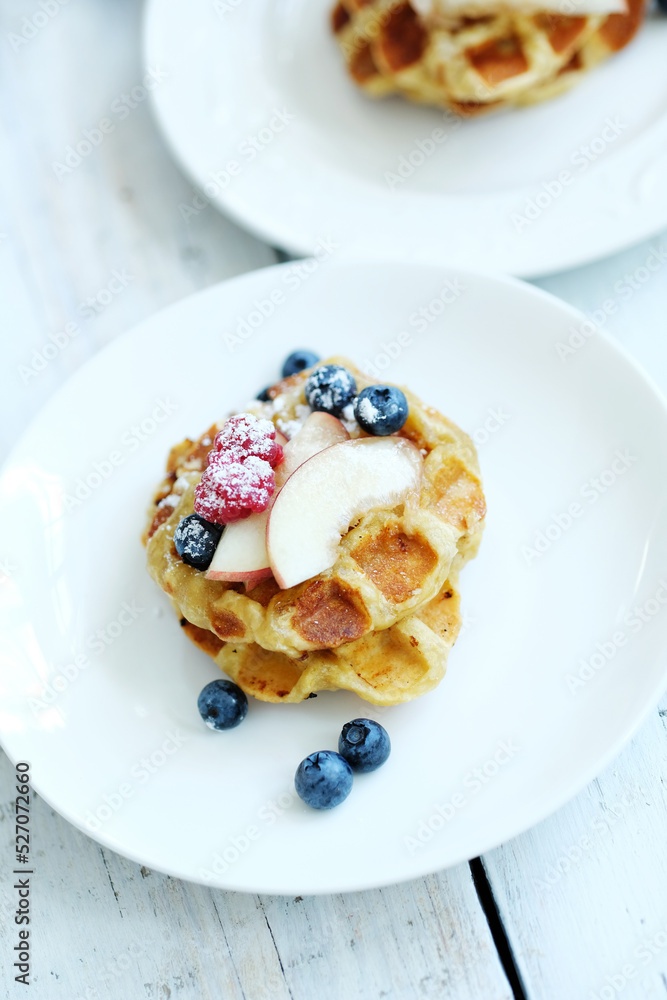 Mini Waffles with berries for the breakfast on a white plate Mini Waffles with berries for the breakfast on a white plate