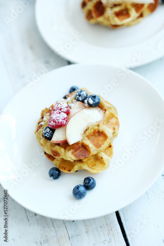Mini Waffles with berries for the breakfast on a white plate