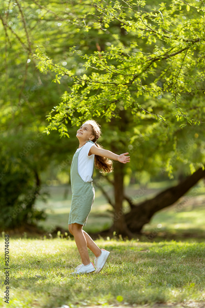 Cute little girl standing in the park Cute little girl standing in the park