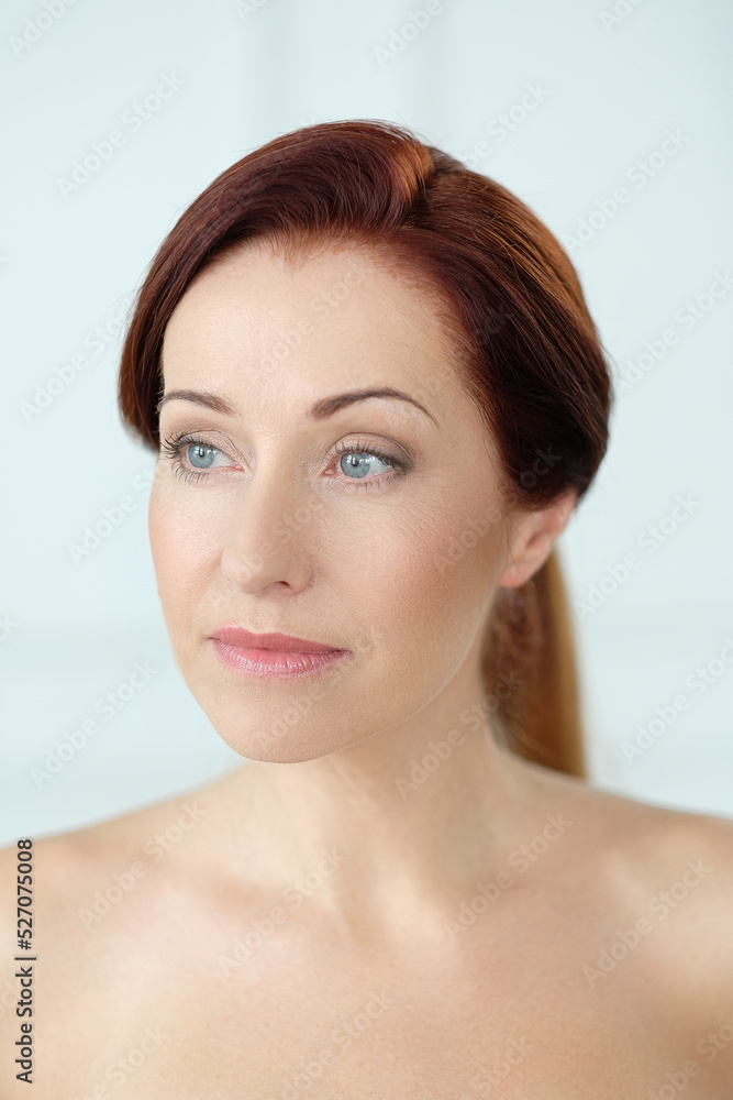 Close-up portrait of a beautiful,mature woman with blue eyes looking away Close-up portrait of a beautiful,mature woman with blue eyes looking away