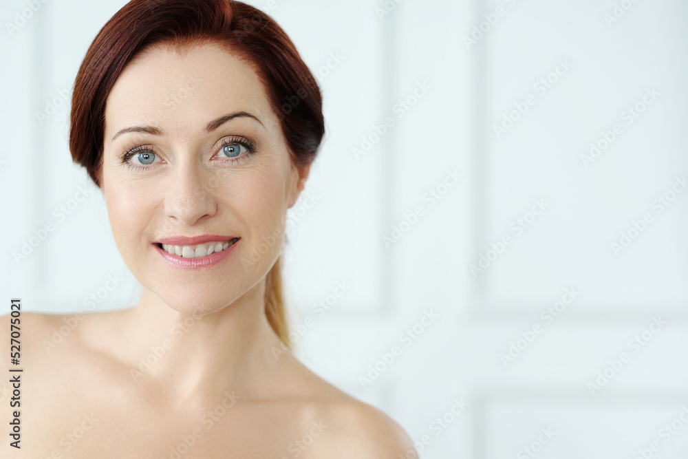 Close-up portrait of a beautiful,mature woman with blue eyes looking into the camera and smiling Close-up portrait of a beautiful,mature woman with blue eyes looking into the camera and smiling