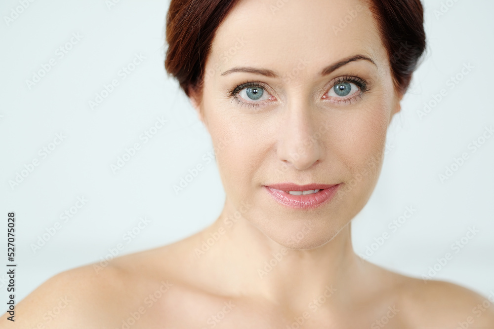 Close-up portrait of a beautiful,mature woman with blue eyes looking into the camera Close-up portrait of a beautiful,mature woman with blue eyes looking into the camera