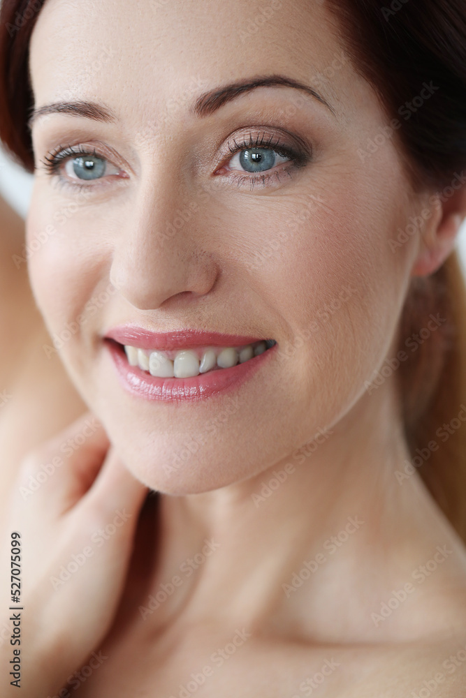 Close-up portrait of a beautiful,mature woman with blue eyes looking away and smiling