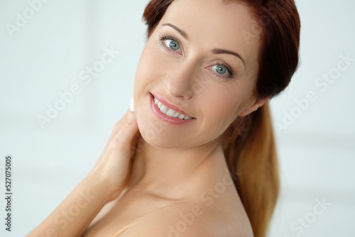 Close-up portrait of a beautiful,mature woman with blue eyes looking into the camera and smiling