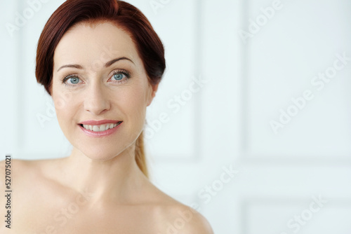 Close-up portrait of a beautiful,mature woman with blue eyes looking into the camera and smiling