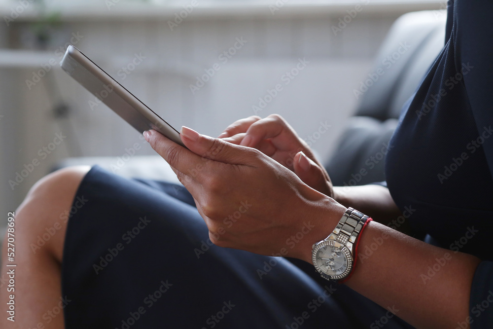 Image of a beautiful woman` hands  with watch holding digital tablet 
