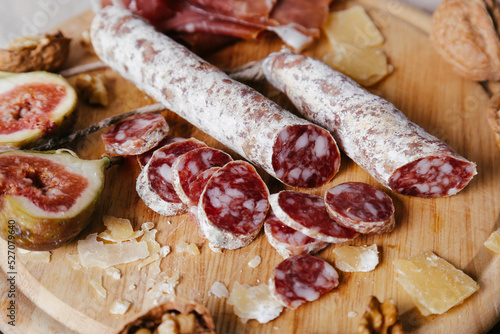 Delicious ring-sliced sausage on a wooden cutting board.