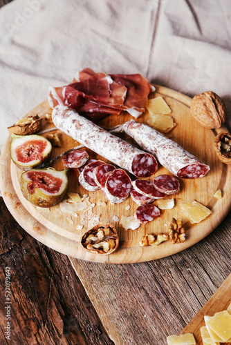 Delicious ring-sliced sausage on a wooden cutting board.