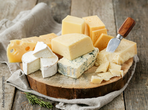 Different kinds of cheese isolated on a wooden surface.