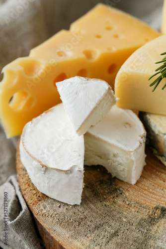Different kinds of cheese isolated on a wooden surface.