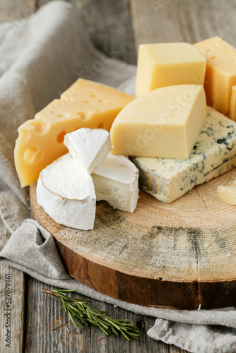 Different kinds of cheese isolated on a wooden surface.