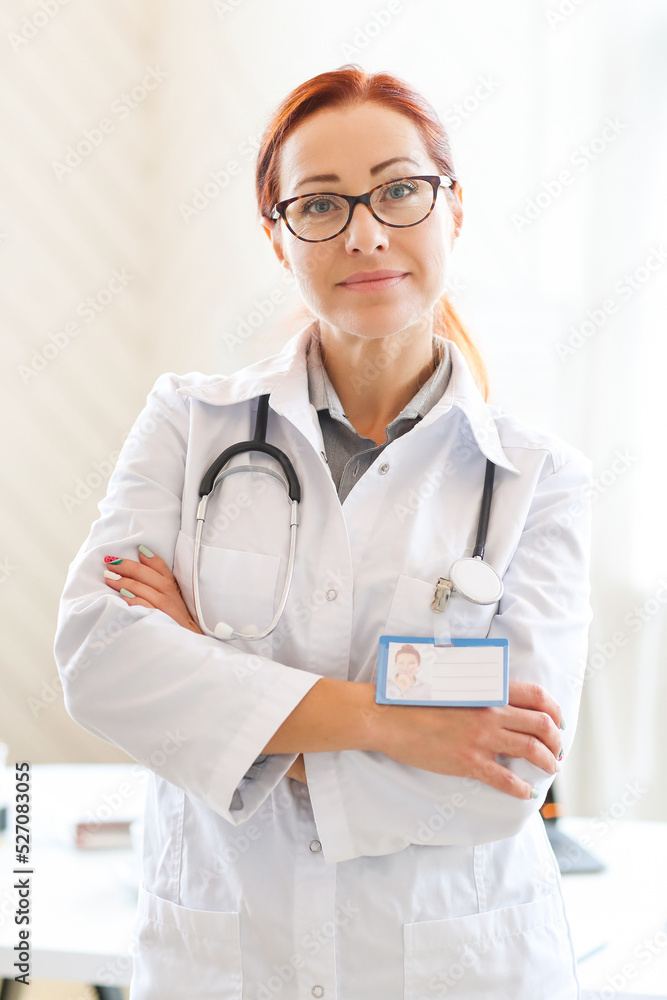 Woman-doctor standing with crossed arms in hospital or clinic and Woman-doctor standing with crossed arms in hospital or clinic and
