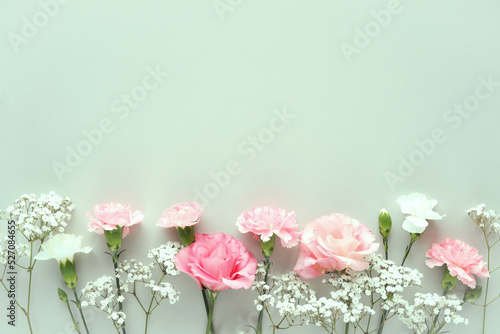 Top view of floral composition with pink roses on a blue background. photo