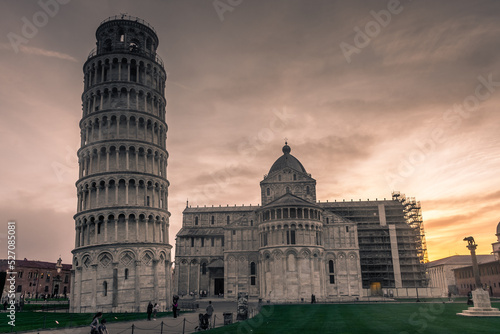 Pisa, Italy, 14 April 2022: View of the Cathedral and the leaning tower at sunset