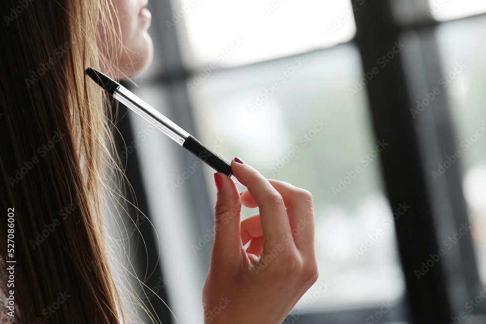 Close view of a young girl holding a pen. Close view of a young girl holding a pen.