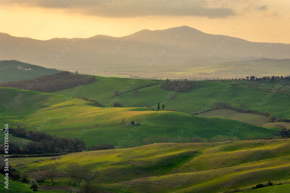 Amazing sunrise over the green hills of the Tuscany countryside,  Italy