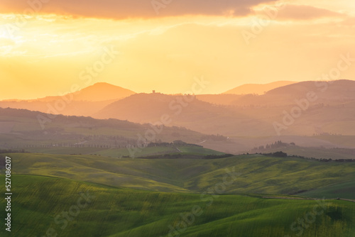 Amazing sunrise over the green hills of the Tuscany countryside, Italy