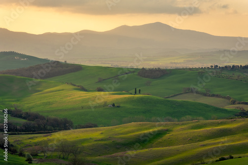 Amazing sunrise over the green hills of the Tuscany countryside, Italy