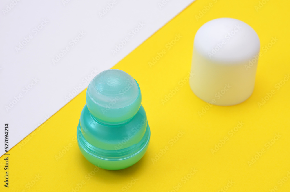 roll-on deodorant on yellow background close-up roll-on deodorant on yellow background close-up