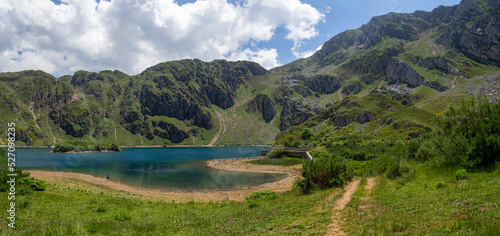 Vistas del lago del Valle con un paisaje de naturaleza verde en las montañas que rodean el lago en Somiedo con formas curvas, verde y azul en Asturias, en verano de 2021 photo