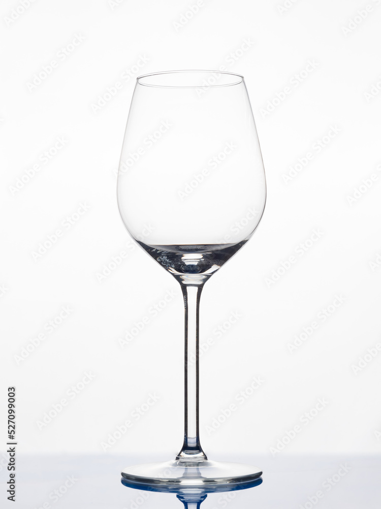Glass wine glass on a white background. Empty goblet.