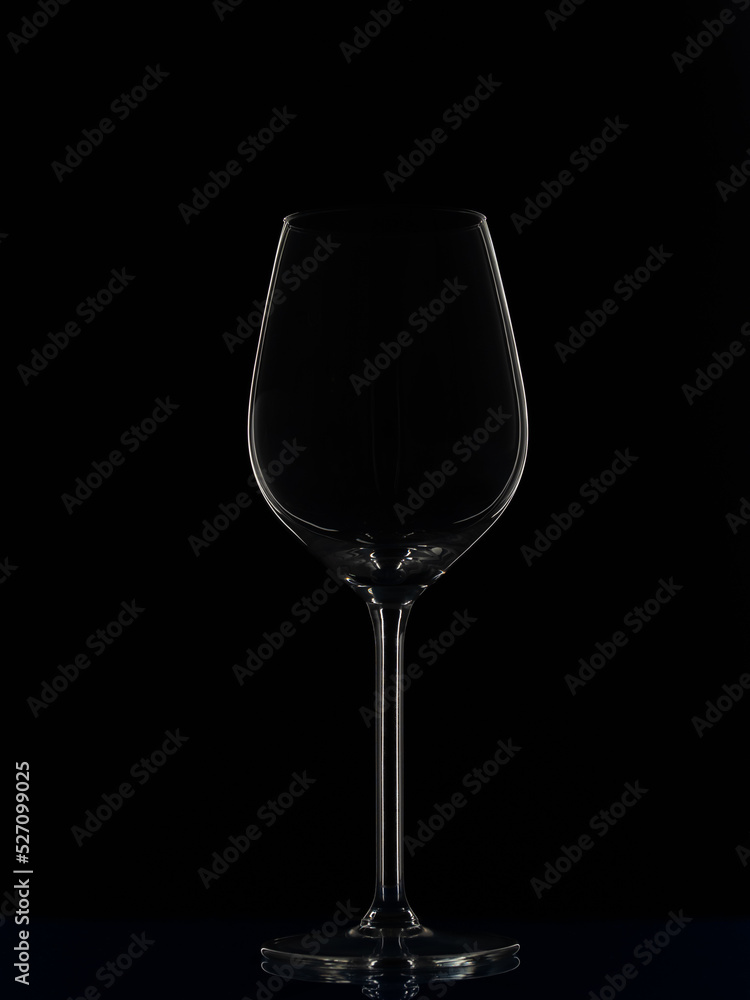 Glass wine glass on a black background.