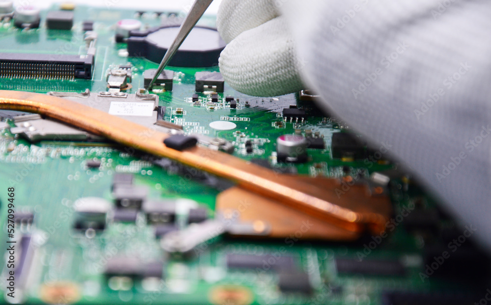 Side view as mechanic fixing motherboard