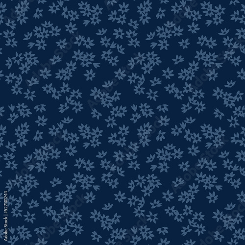 Trendy seamless vector floral pattern. Endless print made of small blue flowers. Summer and spring motifs. Dark blue  background. Stock vector illustration.