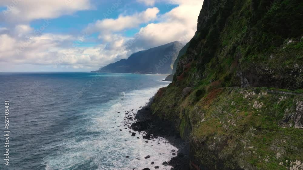 The Atlantic ocean seaside with a waterfall. The seashore waterfall on Madeira. The Atlantic ocean seaside with a waterfall. The seashore waterfall on Madeira.