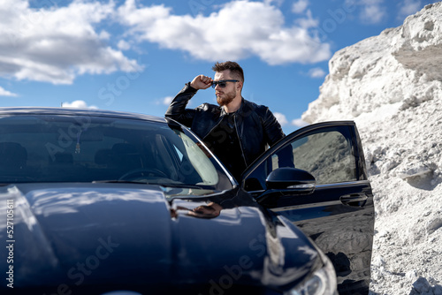Stylish male model with car. Handsome cool guy in casual cloth.