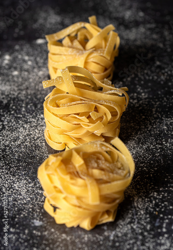 Food photography of  raw pasta  tagliatelle  fettuccine  macro