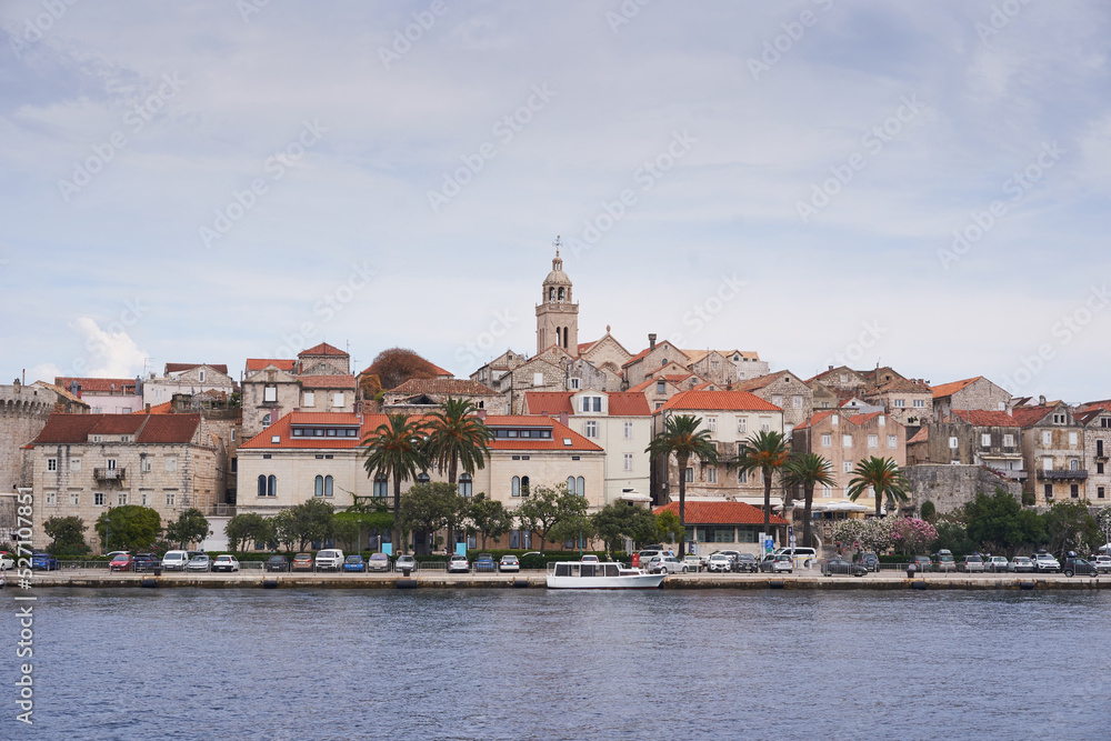 Beautiful old historic city Korcula on the island Korcula in south dalmatia region in Croatia. Picture taken during the cloudy summer day from the sea. Place to spend summer vacation in south Europe.