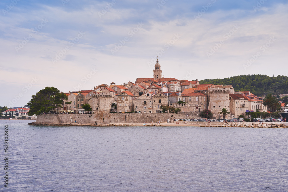 Beautiful old historic city Korcula on the island Korcula in south dalmatia region in Croatia. Picture taken during the cloudy summer day from the sea. Place to spend summer vacation in south Europe.