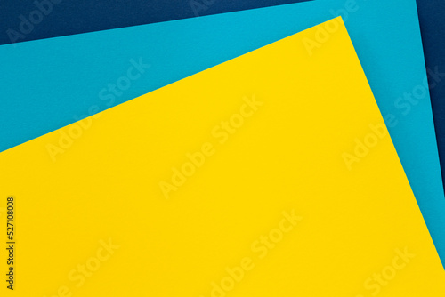 Abstract colored paper texture background. Minimal geometric shapes and lines in light blue, navy blue, yellow colors