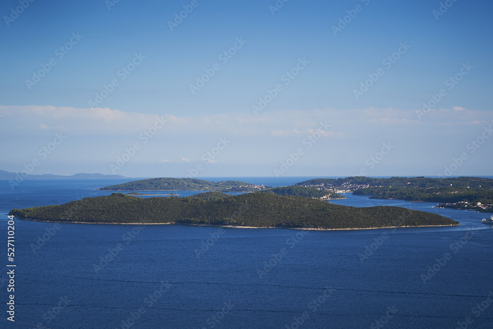 Landscape picture of the south dalmatian coast, clear adriatic sea, rocks, woods and islands in Croatia. Picture is taken in hot summer evening. Beautiful place to spend summer vacations in Europe.