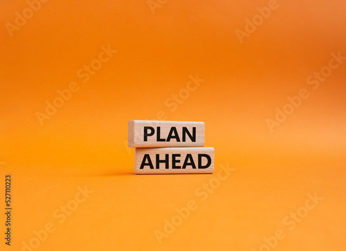Plan ahead symbol. Wooden blocks with words Plan ahead. Beautiful orange background. Businessman hand. Business and Plan ahead concept. Copy space.