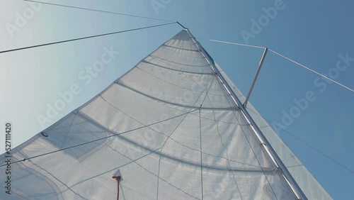 bottom view of the raised sail. a sail filled with wind