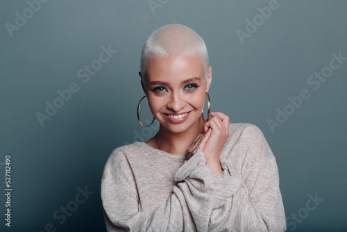 Millenial young woman with short blonde hair smiling portrait photo