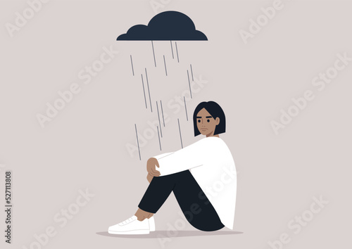 A young upset character hugging their knees, a black rain cloud hovering above them