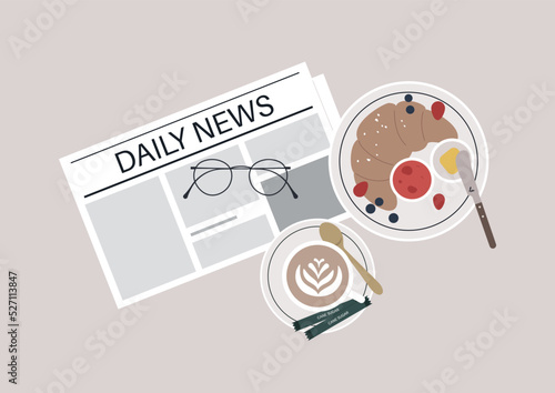 Morning habits, breakfast with coffee, croissant, and a newspaper