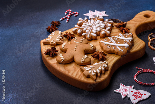 Elements of Christmas decorations, sweets and gingerbread on a wooden cutting board