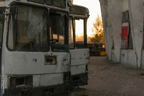 old abandoned broken buses at sunset
