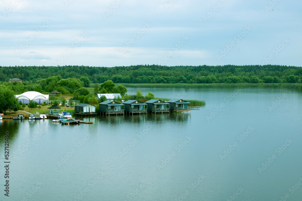 Small wooden houses on the river on a cloudy day